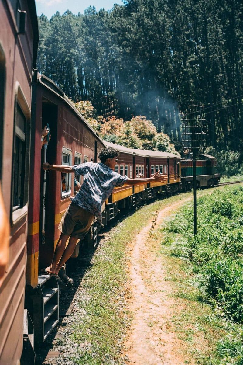 Guest leaning out of the hill country train on a Sri Lanka trip from The Surfer camp