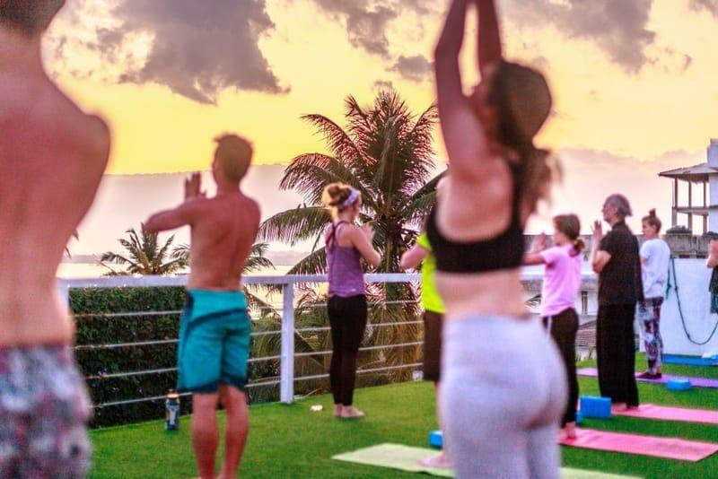 Sunset yoga class on the lawn by the sea at The Surfer Beach Camp, Weligama